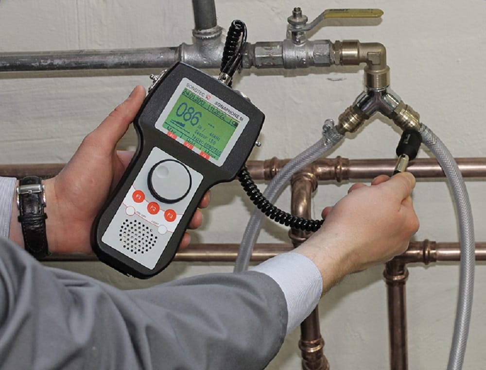 Plumber testing pipes with electronic leak detection equipment in Oregon City