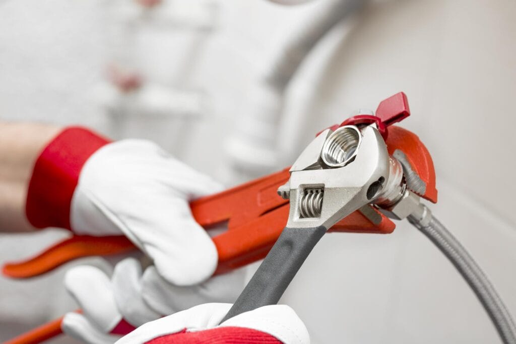 Plumber holding pipe wrenches for an emergency repair in Oregon City