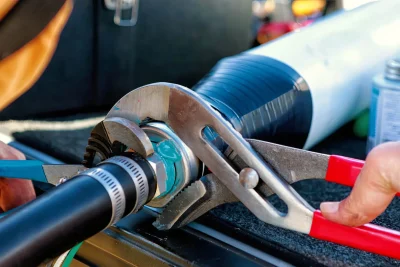 Technician tightening an industrial pipe connection in Oregon City