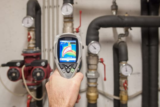 Plumber using a thermal imaging camera to inspect pipes in Oregon City