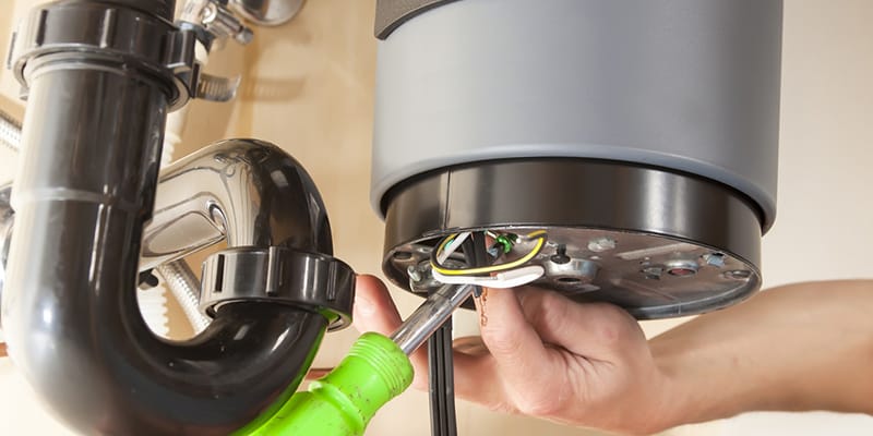 Technician repairing the heating element of a water heater in Oregon City
