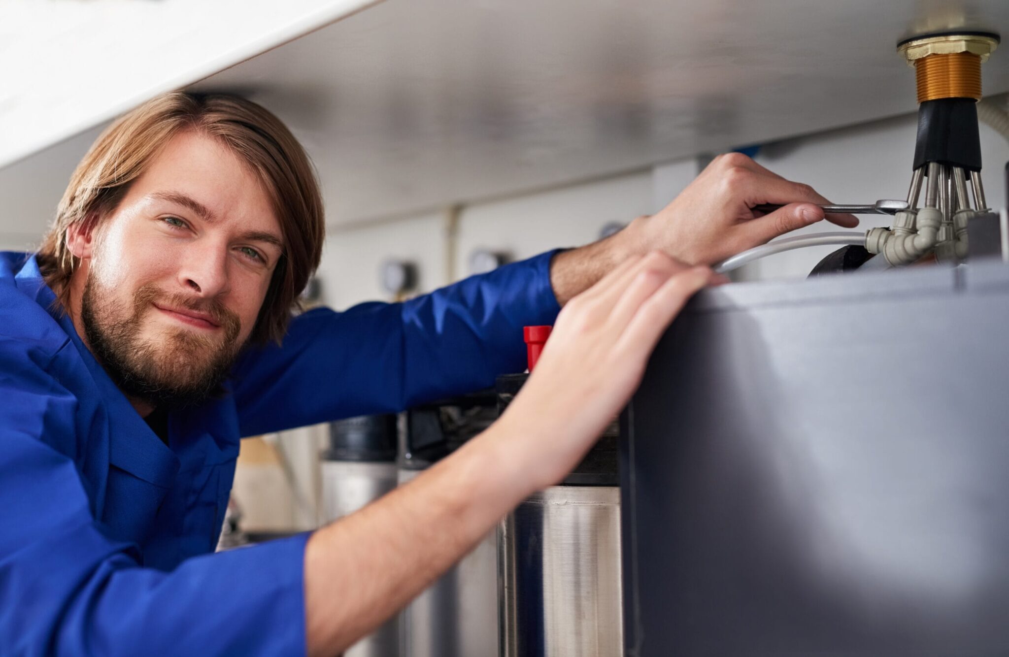 Technician servicing a residential water heater tank in Oregon City