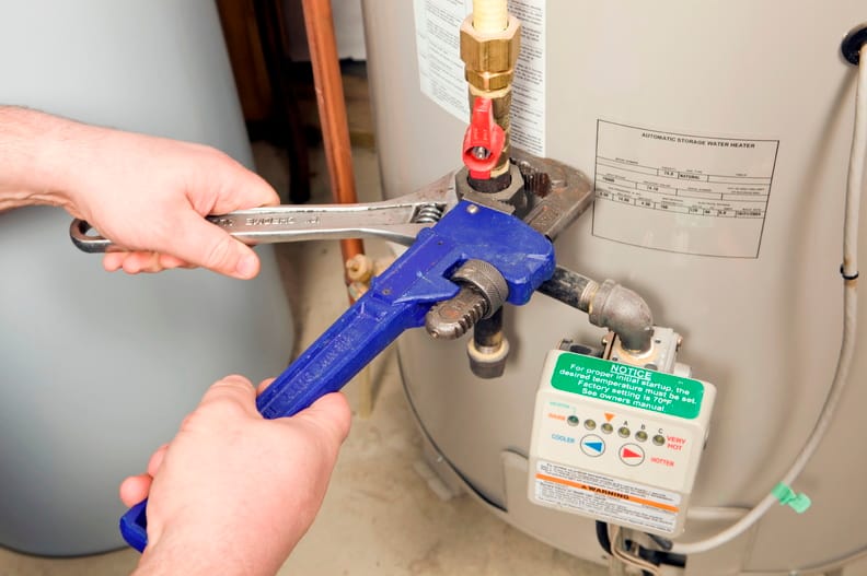 Plumber repairing a water heater valve in Oregon City